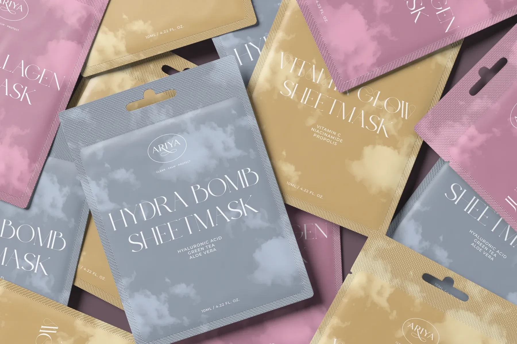 ARIYA sheet masks scattered in pink, gold and grey-blue