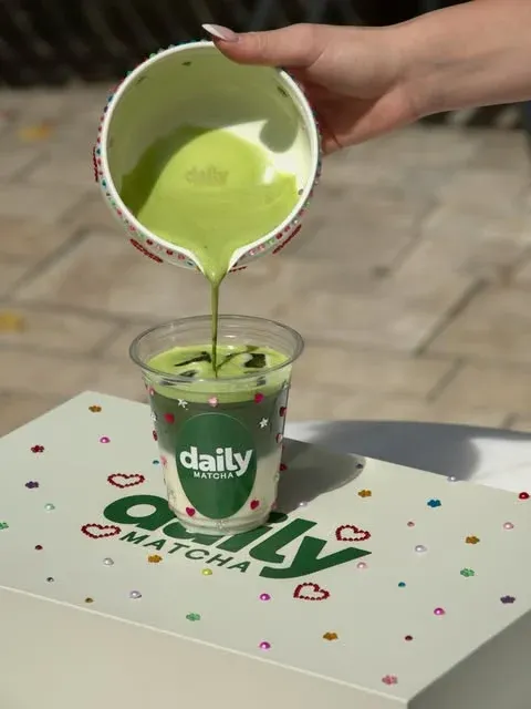 Matcha poured into a branded Daily Matcha cup