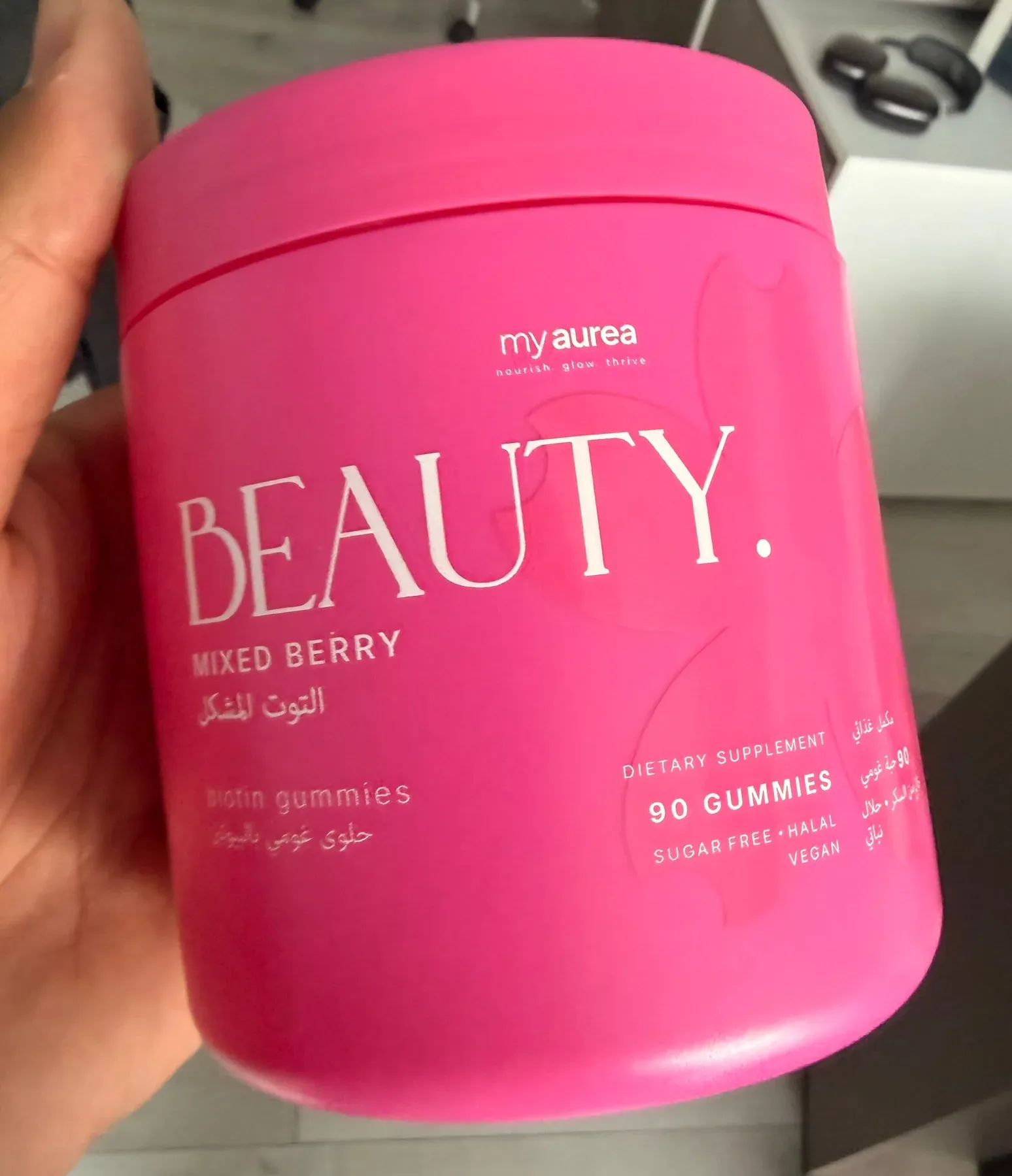 The finished my beauty jar, hot pink, held in a hand