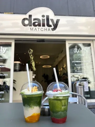 Matcha drinks in front of a Daily Matcha shop