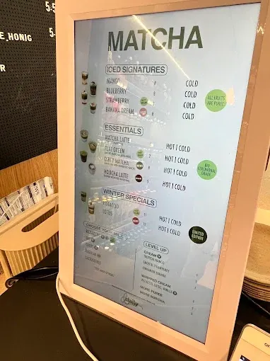 Two matcha drinks in front of the shop