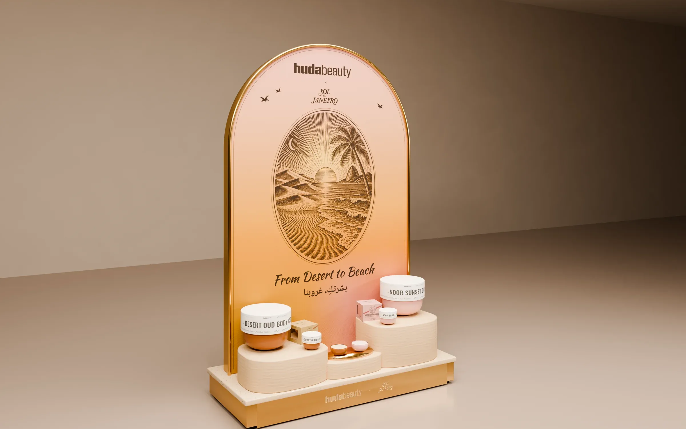 The freestanding display: brass arch, engraved desert-to-beach medallion, dune plinths with both creams