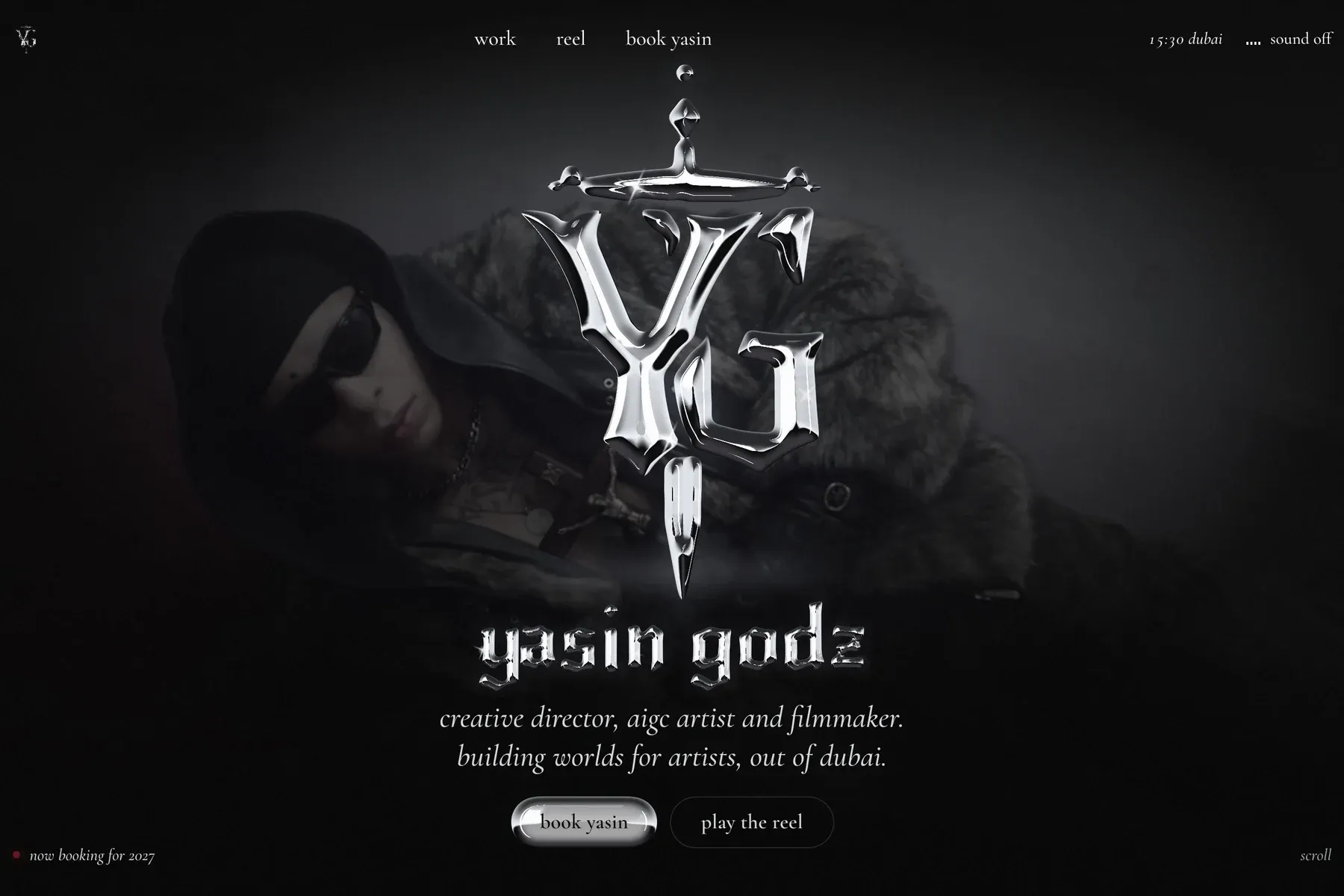 The Yasin Godz website: the silver YG dagger monogram over a dimmed film